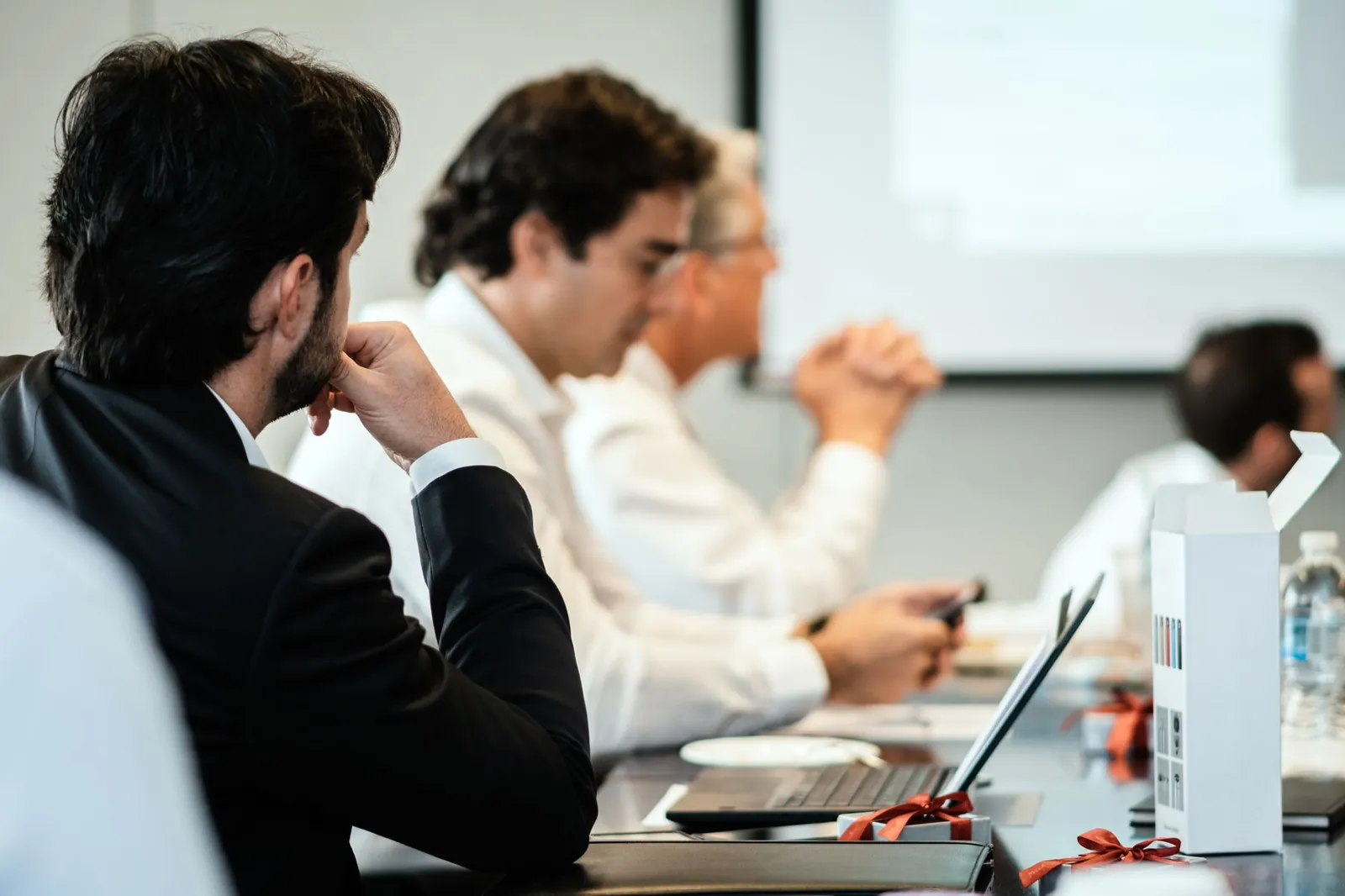 Corporate professionals in a formal meeting environment, focused on teamwork and collaboration. Stock photo for the ALFA News guide: How to Find Company Filings in India: A Guide for Investors.