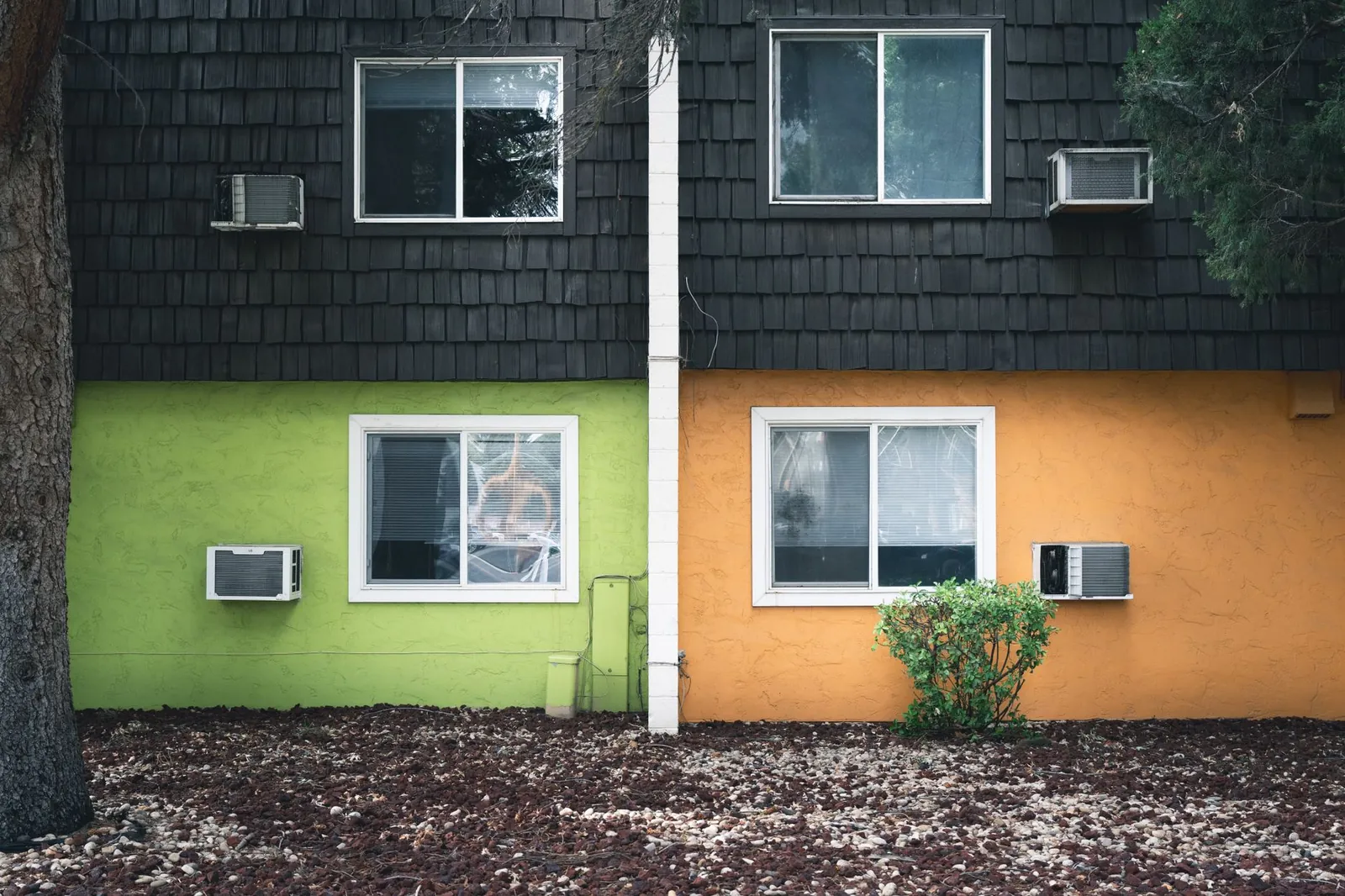 Vibrant split-color apartment facade with air conditioners in Boise, Idaho. Stock photo illustrating Symphony's product launched story.