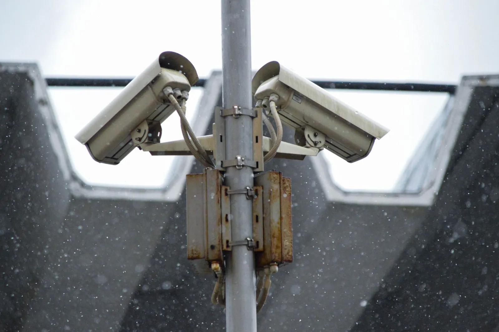 Close-up view of surveillance cameras during a snowfall in urban Москва setting. Stock photo illustrating Zen Technologies' product launched story.
