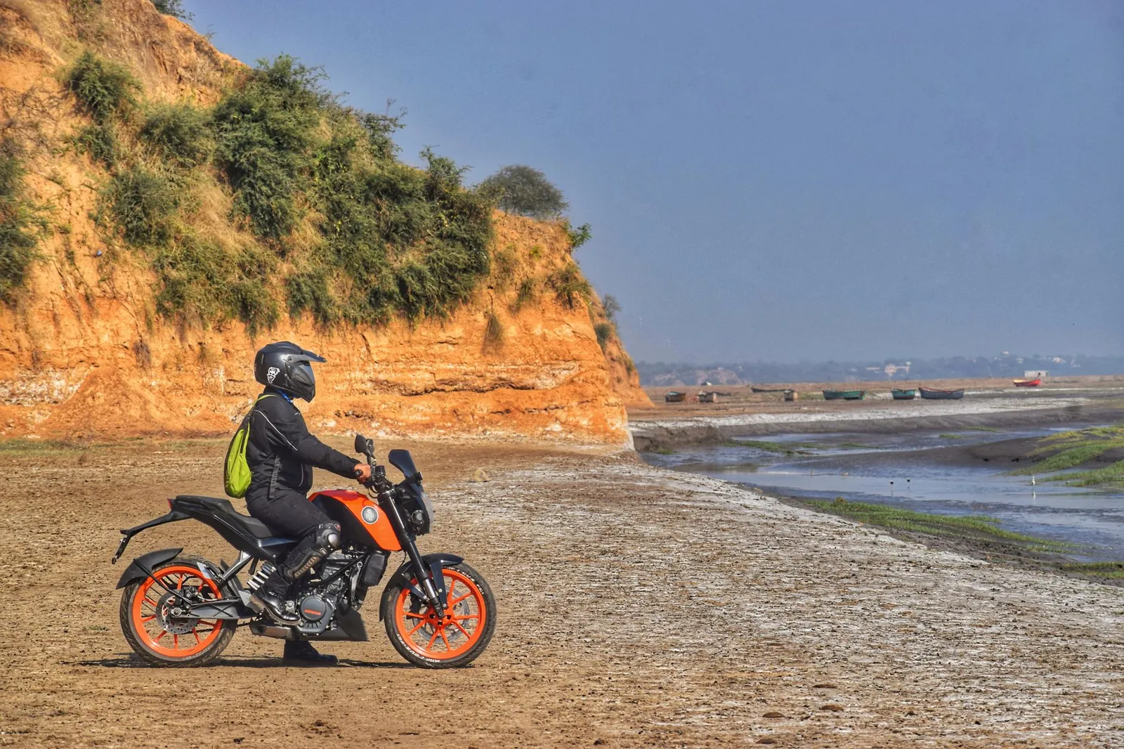 Motorcyclist on an orange bike exploring the rugged landscapes of Kankapura, India. Stock photo illustrating Hero MotoCorp's product launched story.