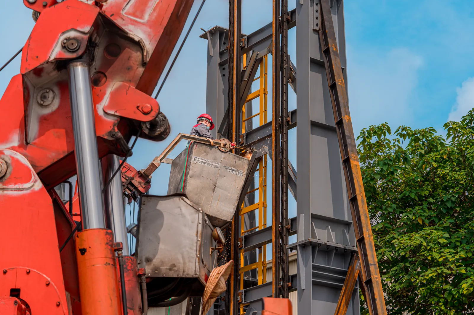 A construction worker operating machinery at an industrial site surrounded by steel structures. Stock photo illustrating SEPC's new order story.