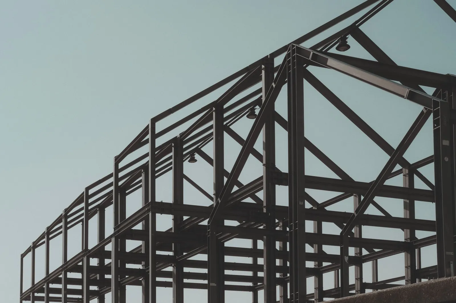 Modern steel framework structure under clear sky, showcasing architectural design. Stock photo illustrating Atmastco's new order story.