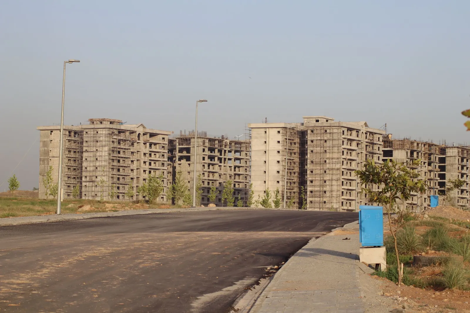 View of unfinished apartment buildings with scaffolding under construction in an urban area. Stock photo illustrating Twamev Construction and Infrastructure's new order story.