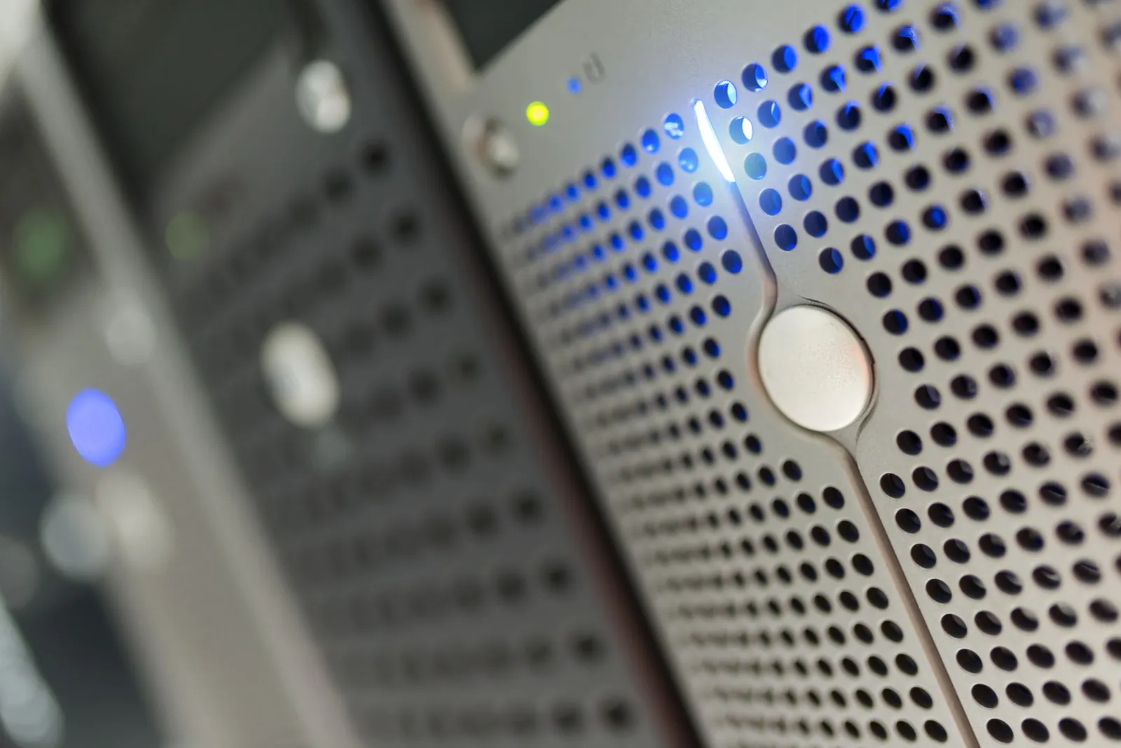 Focused detail of a modern server rack with blue LED indicators in a data center. Stock photo illustrating Reliable Data Services' fund raise story.
