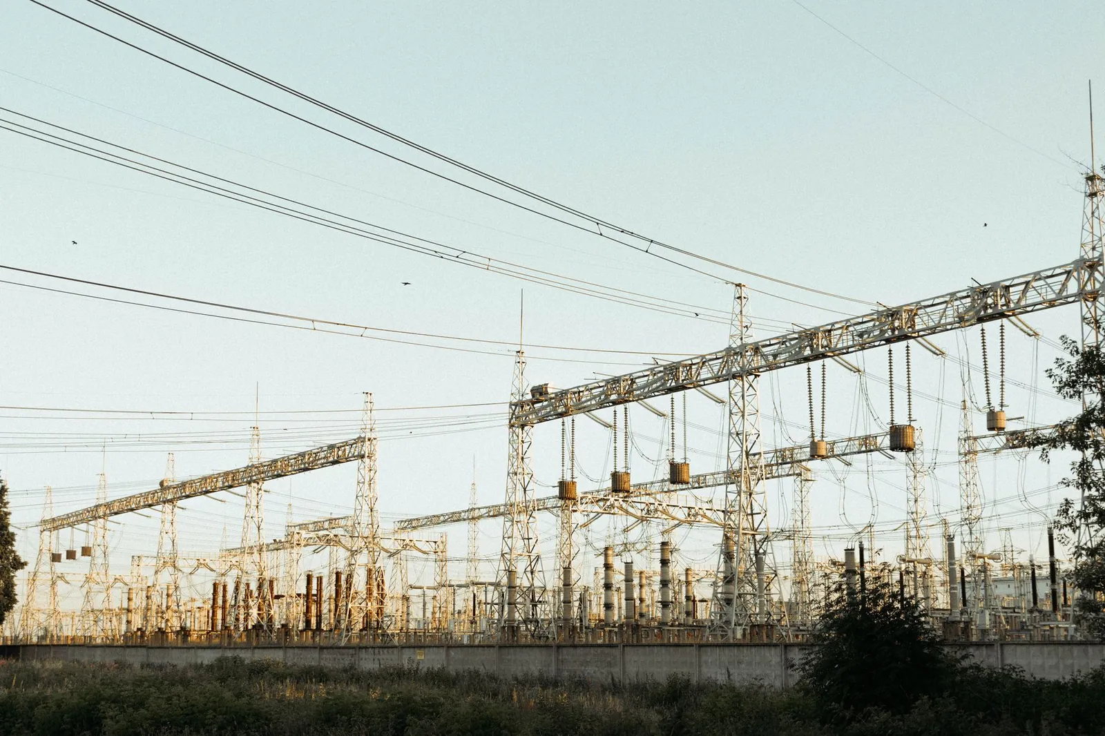 A wide view of an industrial electrical substation with power lines and towers outdoors. Stock photo illustrating Parth Electricals & Engineering's new order story.