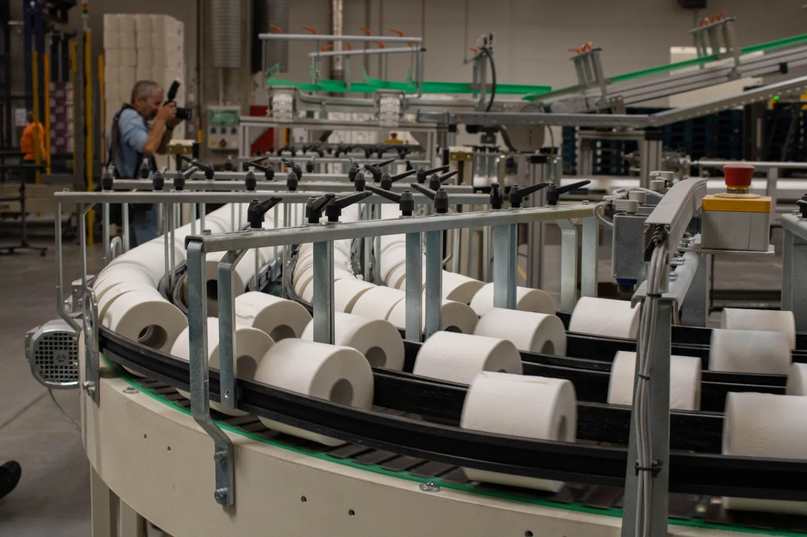 Photographer captures a production line for toilet paper in an industrial setting. Stock photo illustrating Hindustan Foods' earning call story.