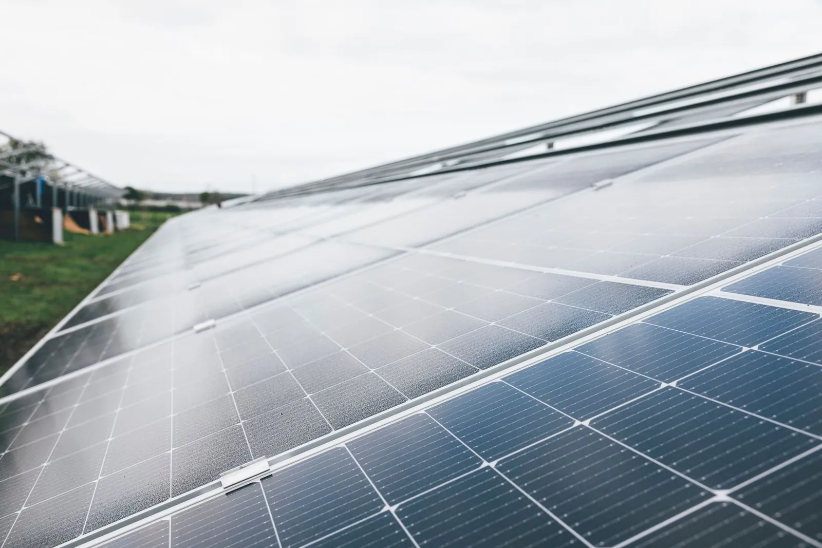 Detailed close-up shot of solar panels at an outdoor solar farm under clear sky. Stock photo illustrating Vikram Solar's new order story.