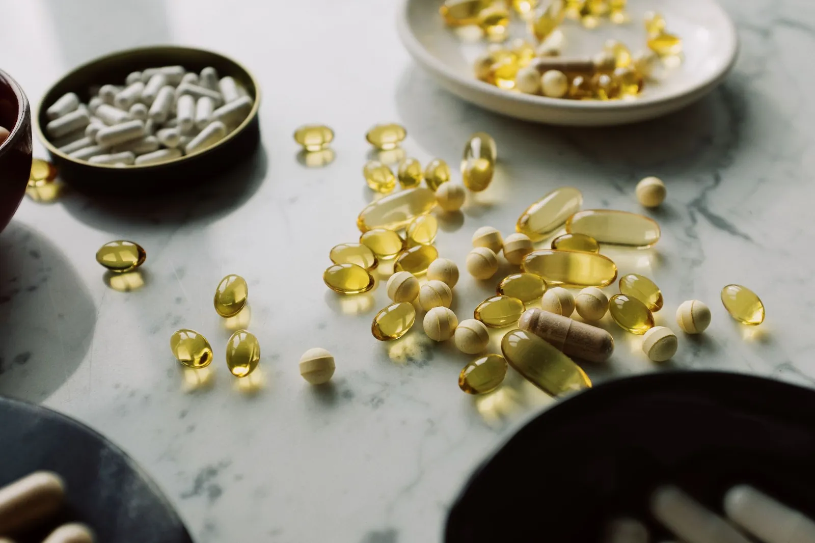A close-up of assorted pills and supplements arranged on a marble surface, highlighting healthcare and wellness themes. Stock photo illustrating Shelter Pharma's product launched story.