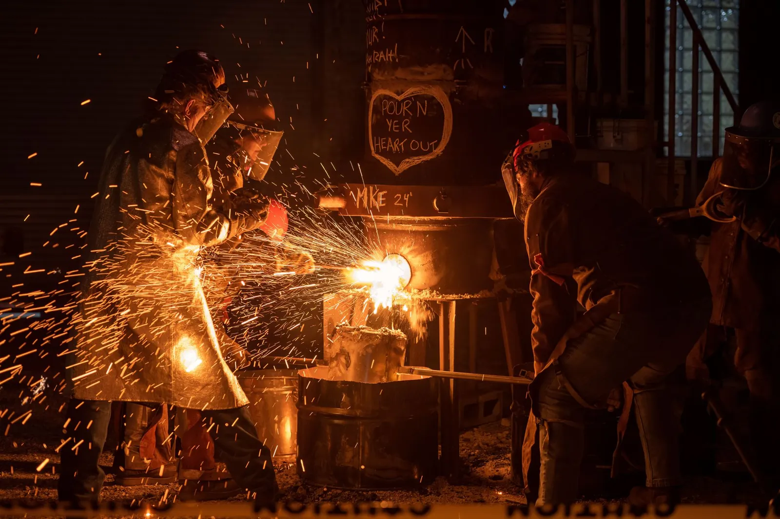 Industrial workers pouring molten metal with sparks flying in Milwaukee workshop. Stock photo illustrating Vardhman Special Steels' earning call story.
