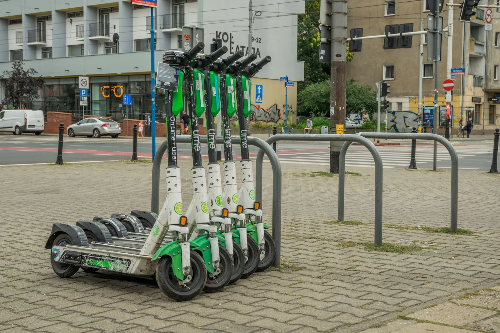 Lime electric scooters parked in Wrocław city center for urban transportation. Stock photo illustrating Ola Electric Mobility's fund raise story.