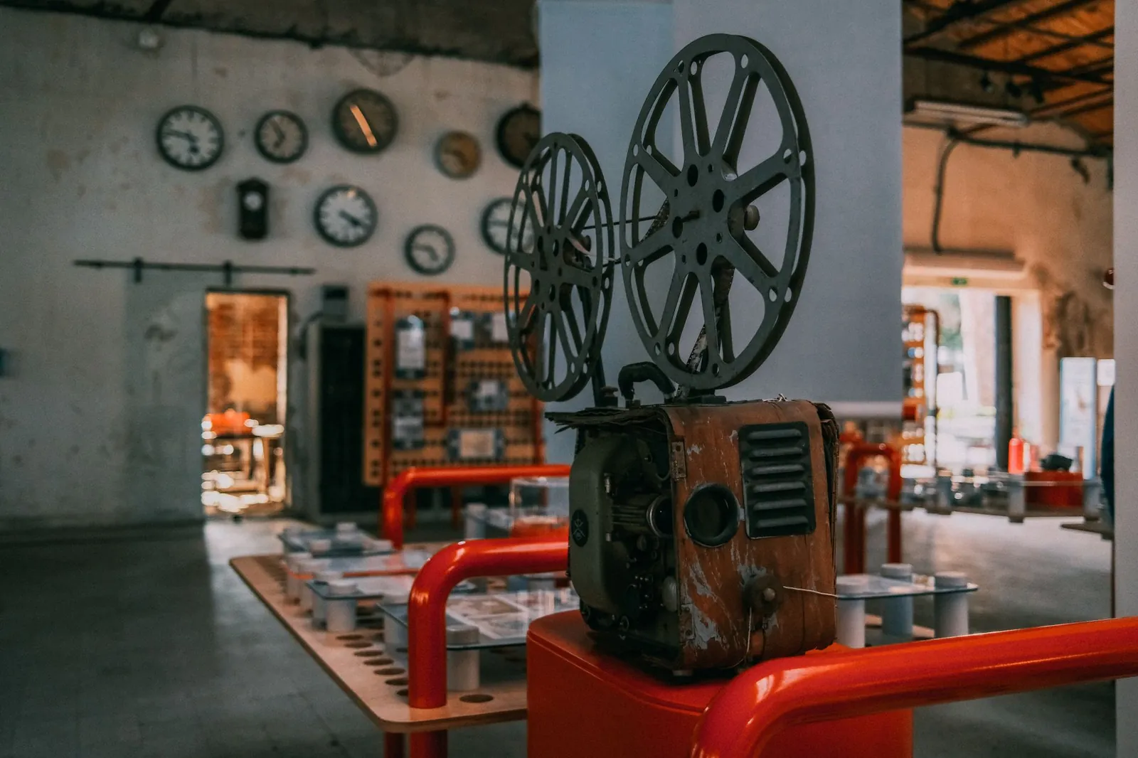 Rustic vintage film projector in an industrial-themed room with wall clocks. Stock photo illustrating Yogi's new order story.