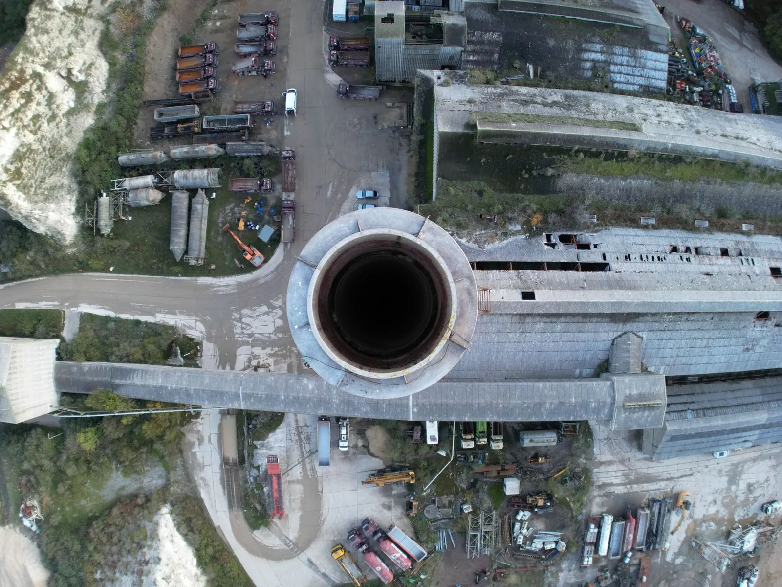 Drone shot capturing an aerial view of industrial factory and chimney, showcasing industrial infrastructure. Stock photo illustrating Sagar Cements' production started story.