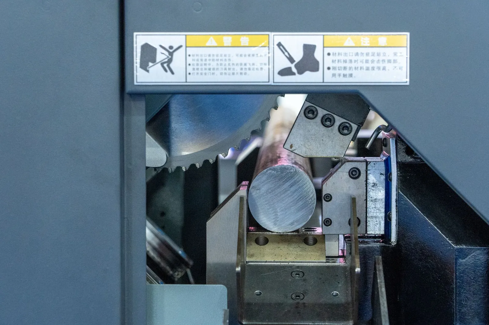 Detailed view of a metal cutting machine in operation, showcasing industrial machinery. Stock photo illustrating OBSC Perfection's earning call story.