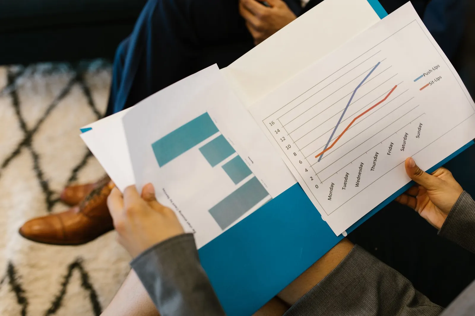 Detailed view of business reports with graphs during a corporate meeting. Stock photo for the ALFA News guide: NSE Corporate Filings: A Guide for Indian Investors.