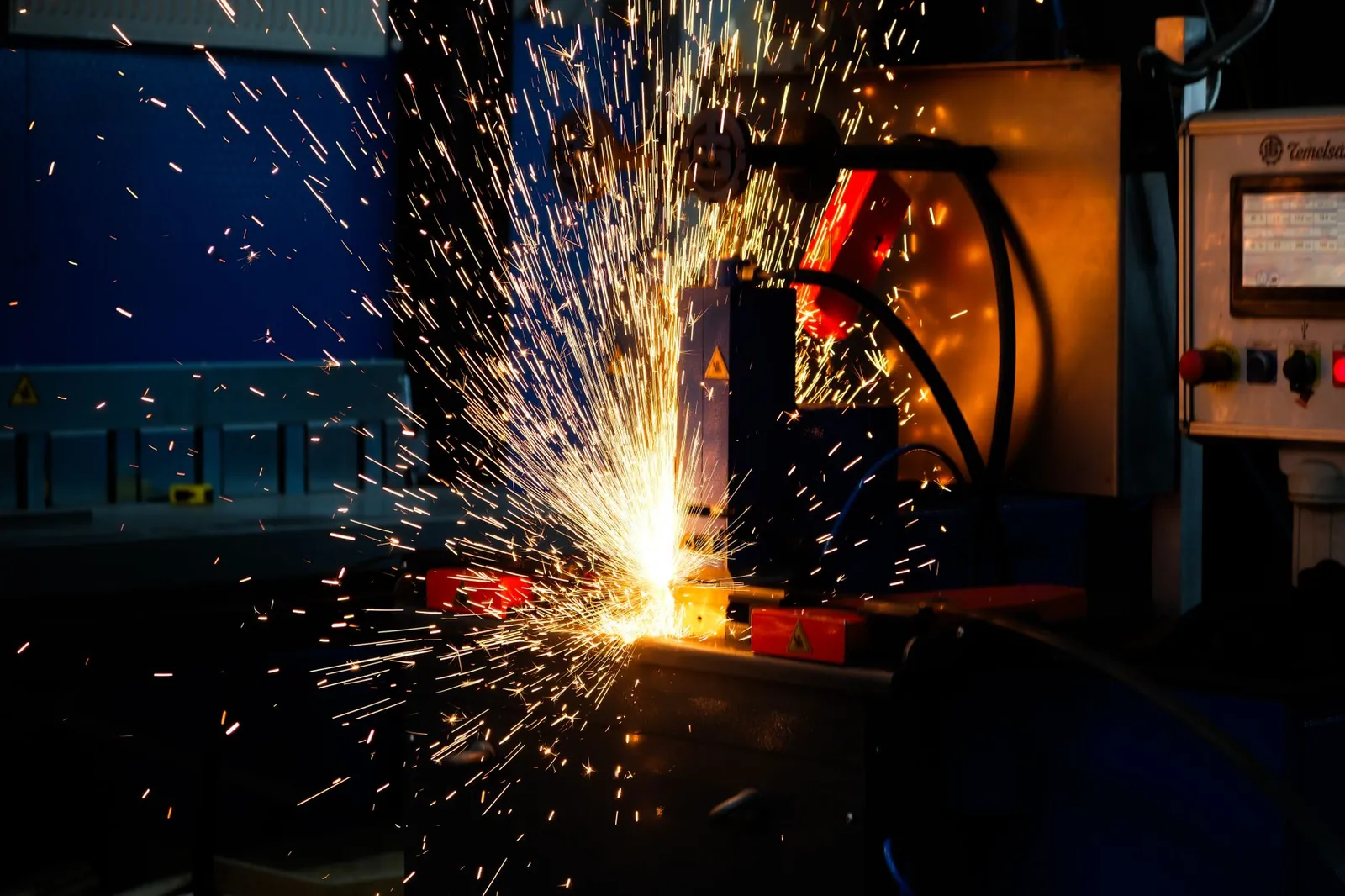 Vibrant display of welding sparks in an industrial setting, highlighting manufacturing processes. Stock photo illustrating Danish Power's expansion story.