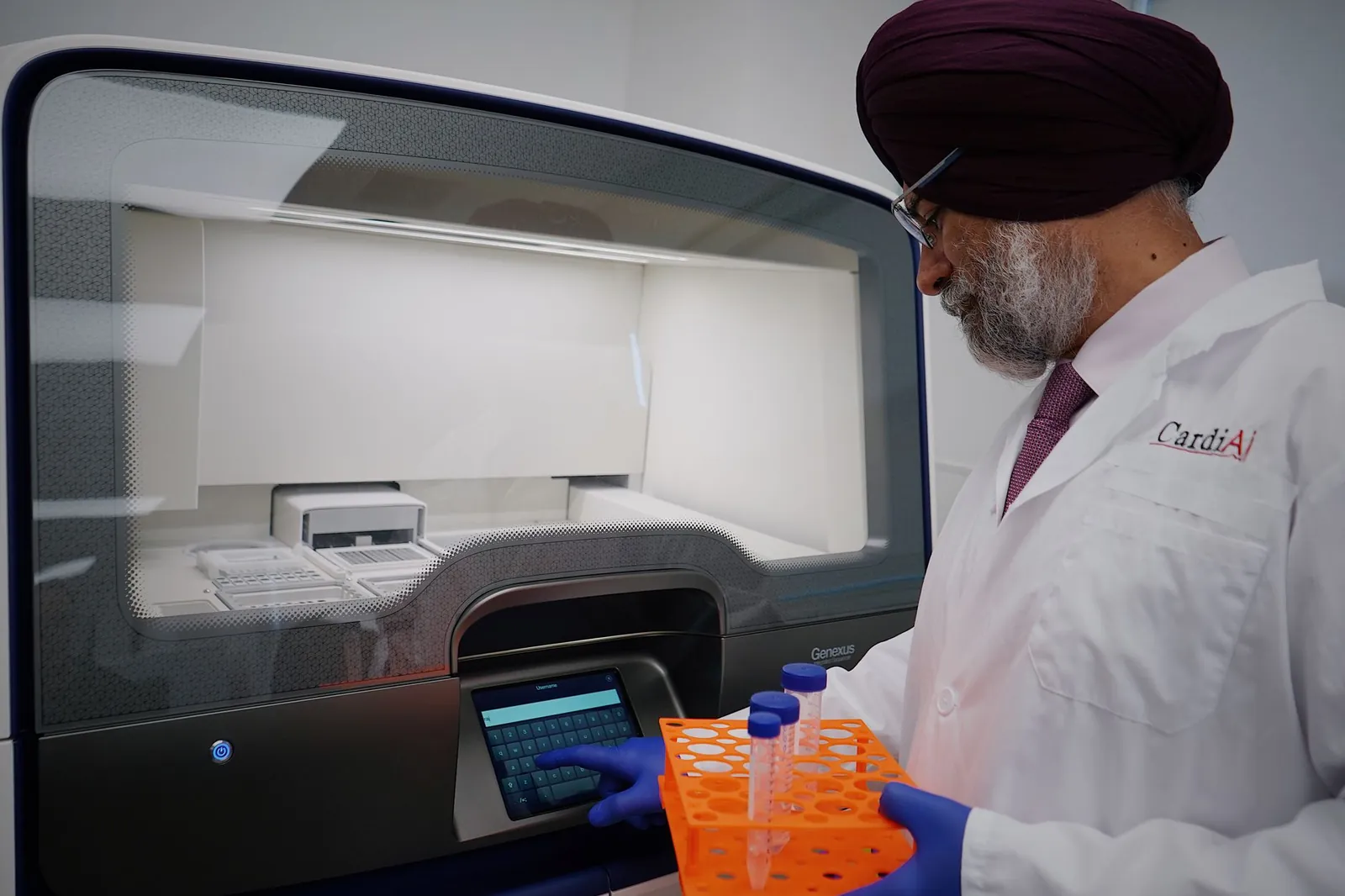 Researcher in lab analyzing samples with high-tech equipment. Wearing protective lab gear. Stock photo illustrating Tata Consultancy Services' product launched story.