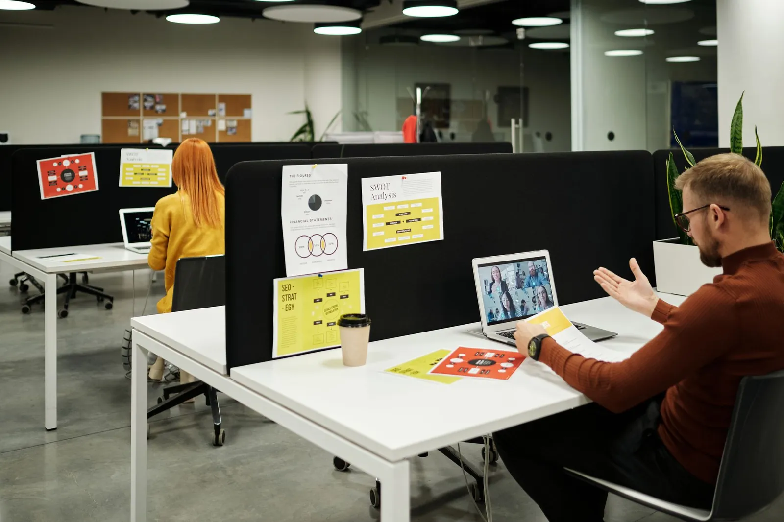 Colleagues working and collaborating virtually at a stylish modern office workspace. Stock photo illustrating Exato Technologies' earning call story.