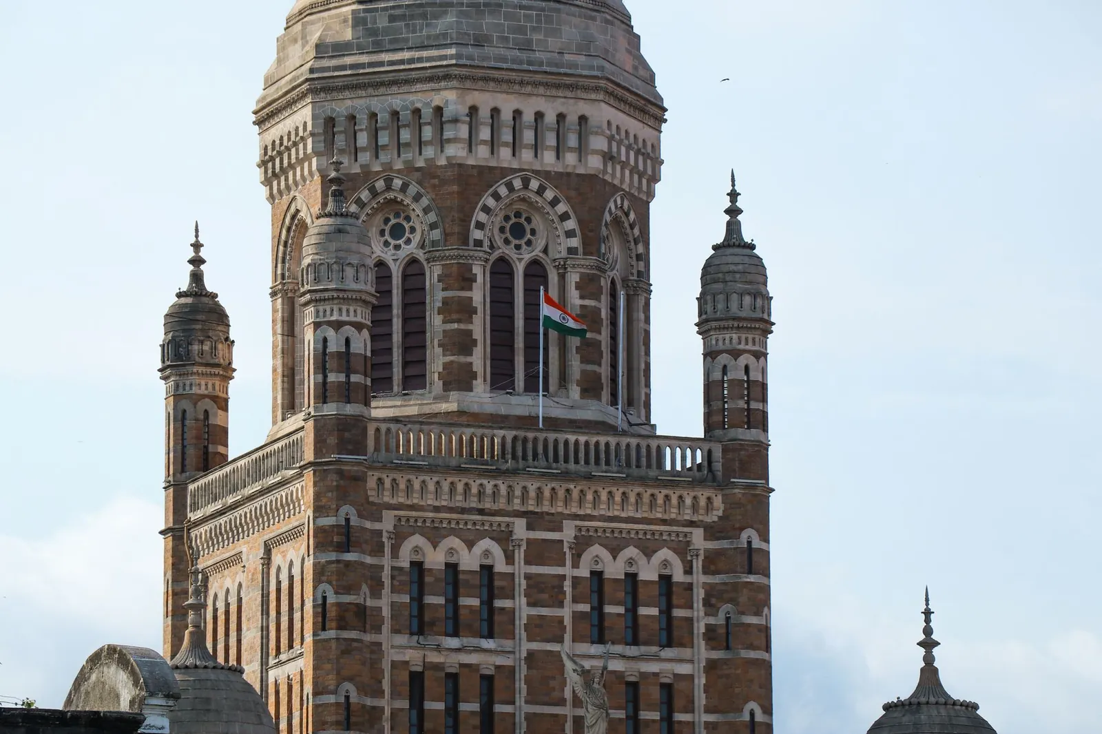 Close-up view of iconic heritage building in Mumbai, showcasing intricate Gothic architecture with Indian flag. Stock photo illustrating Life Insurance Corporation of India's product launched story.