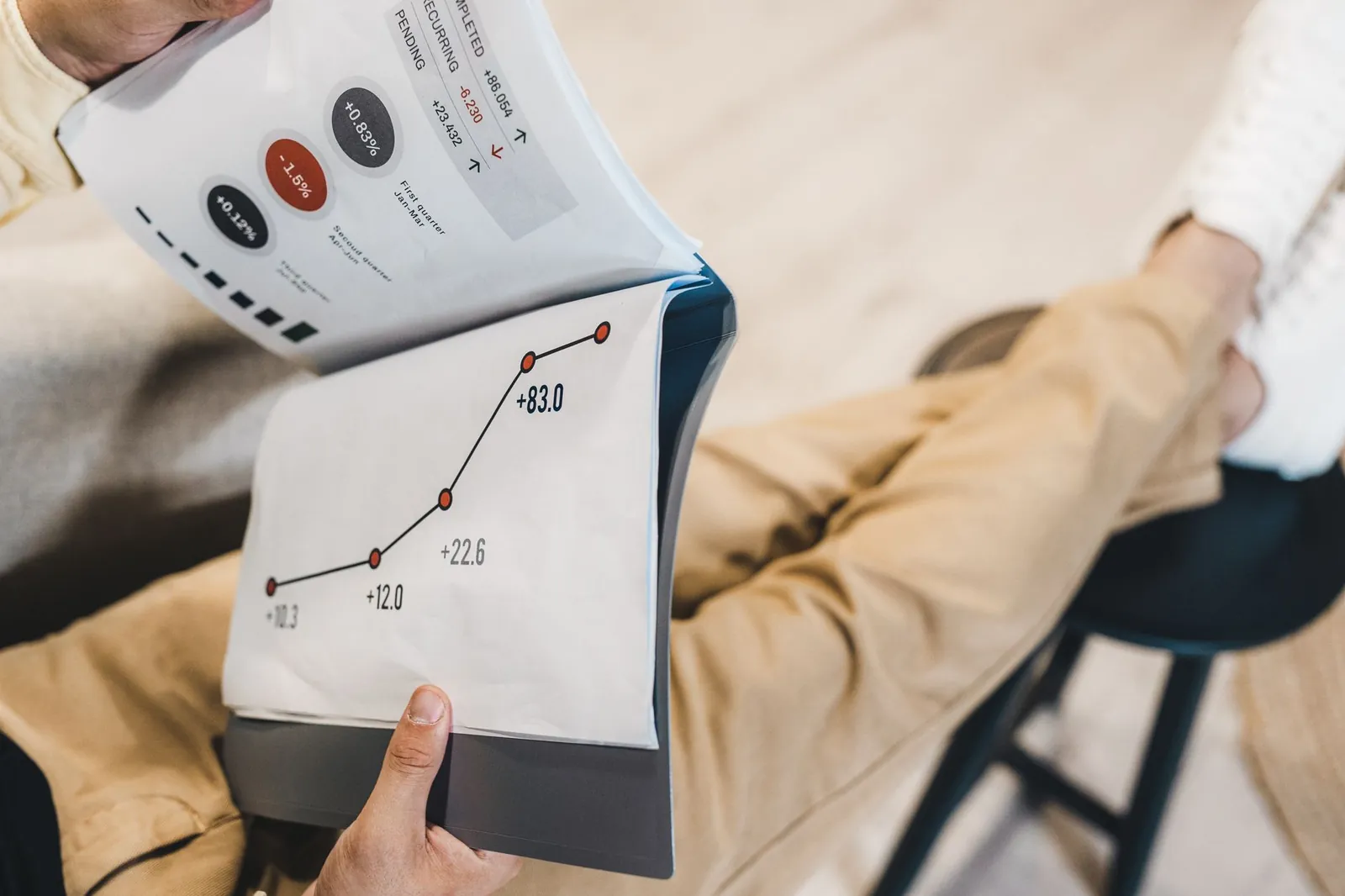 Close-up of a man reviewing business growth charts and statistics in an office setting. Stock photo illustrating Pelatro's fund raise story.