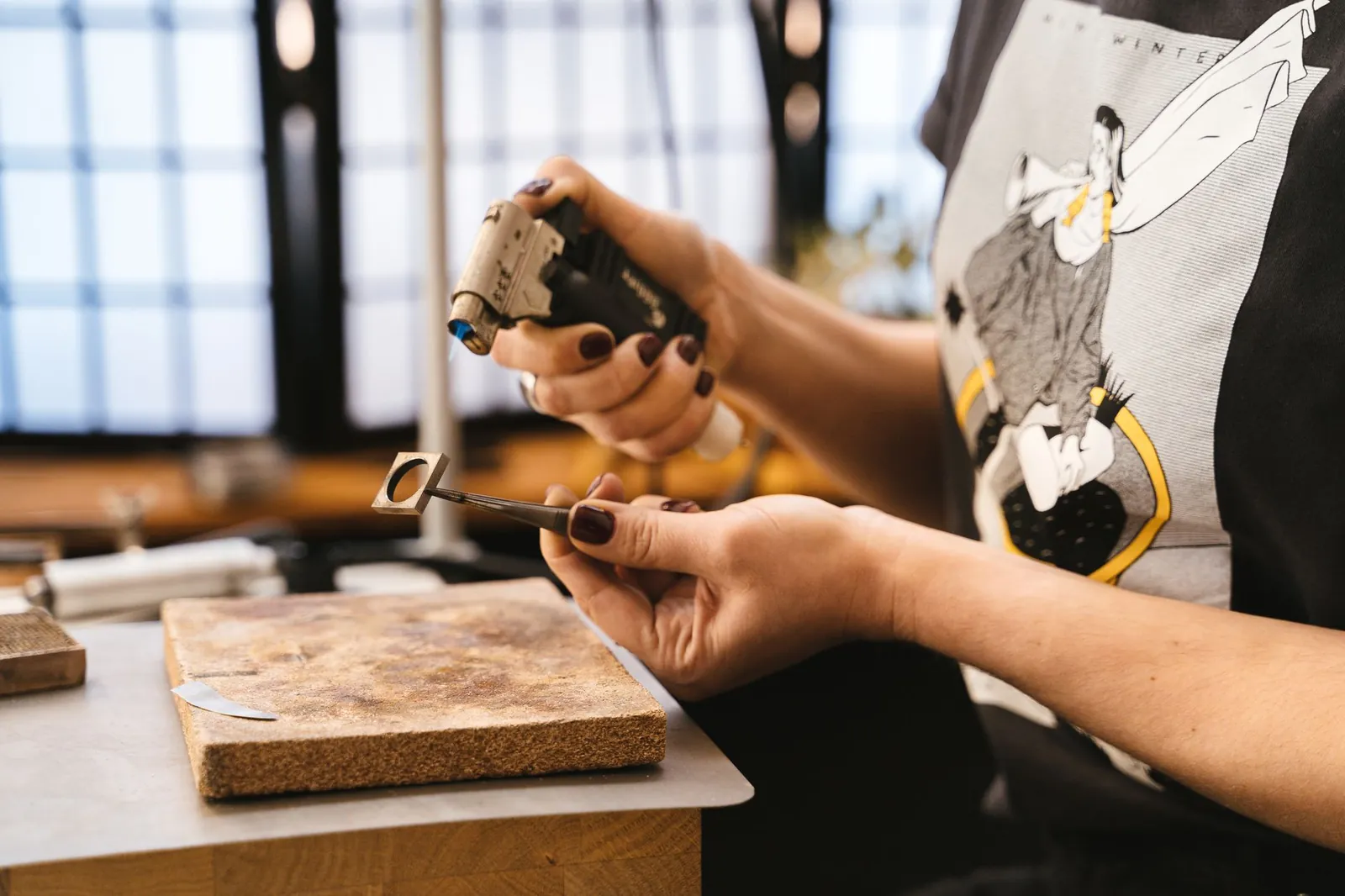 Close-up of artisan crafting jewelry using tools in a workshop setting. Stock photo illustrating Sky Gold And Diamonds' earning call story.