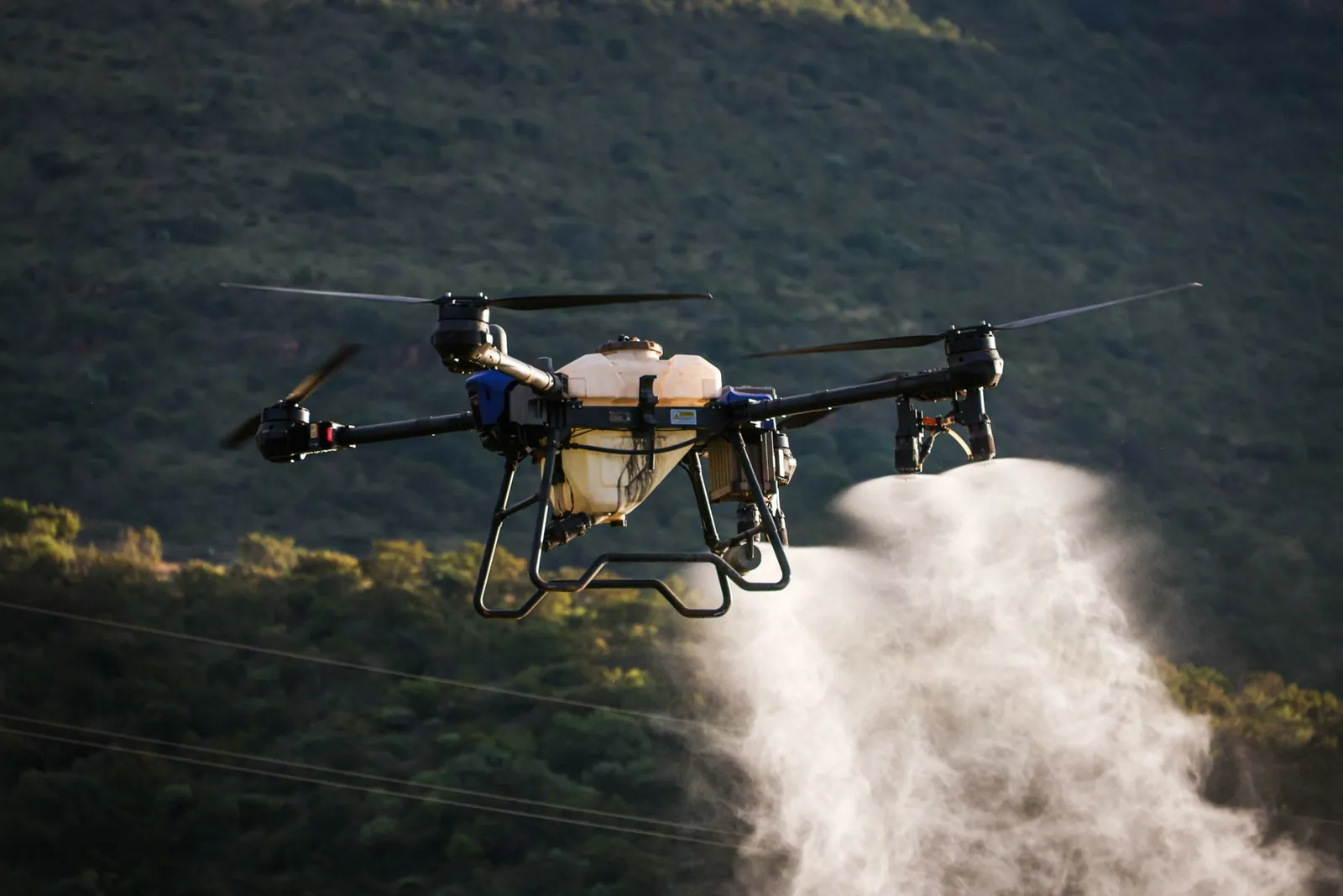 Aerial view of a drone spraying crops with precision agriculture technology. Stock photo illustrating PI Industries' product launched story.