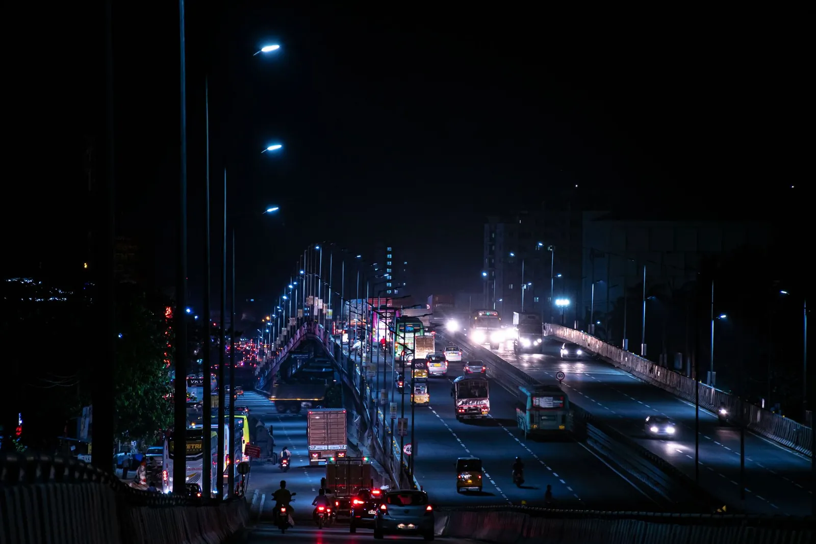 Dramatic night view of a busy highway bridge with moving traffic in India. Stock photo illustrating Indus Infra Trust's earning call story.