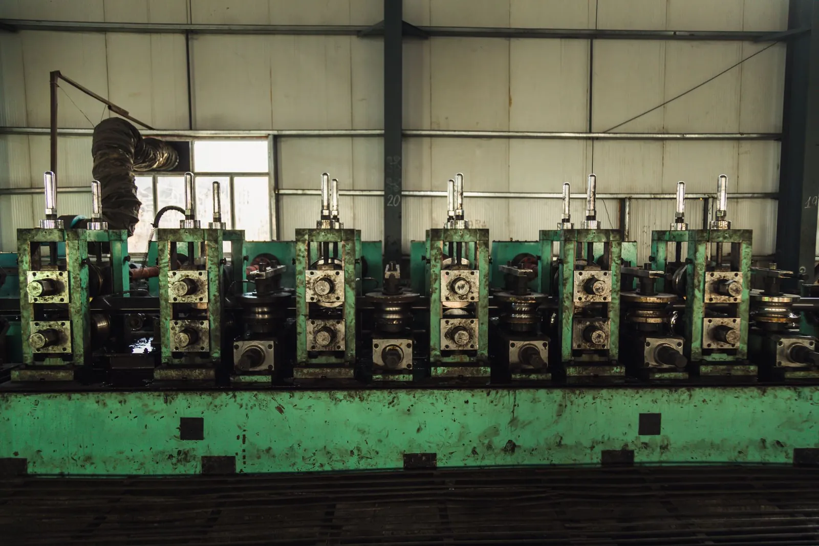 Heavy machinery in a factory setting for manufacturing process. Stock photo illustrating Electrosteel Castings' promoter buying story.