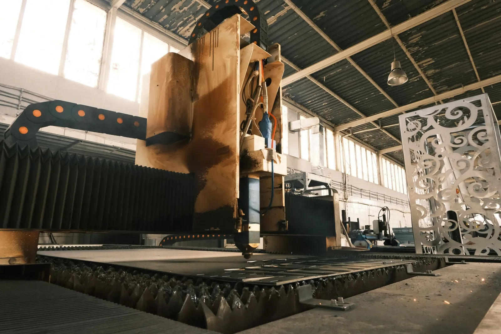 Close-up of a laser cutter in an industrial factory, showcasing modern manufacturing technology. Stock photo illustrating VIP Industries' fund raise story.