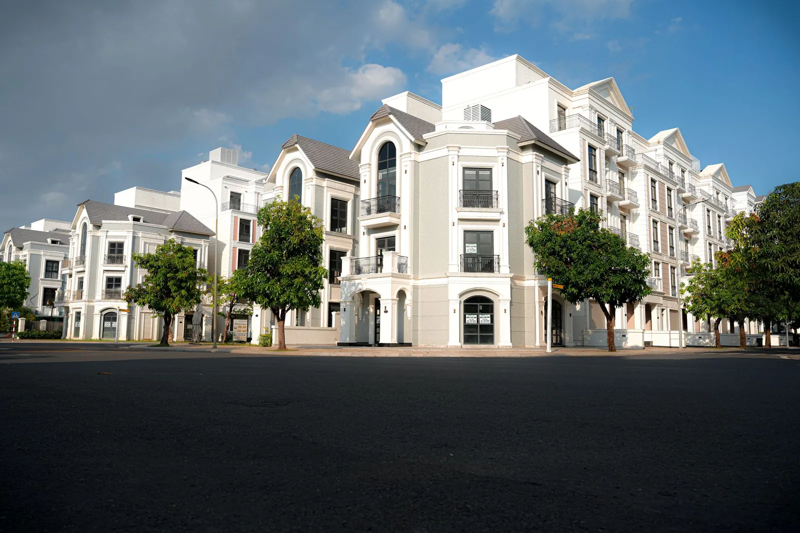 A modern apartment complex with classic architectural design under a bright blue sky. Stock photo illustrating Mahindra Lifespace Developers' product launched story.