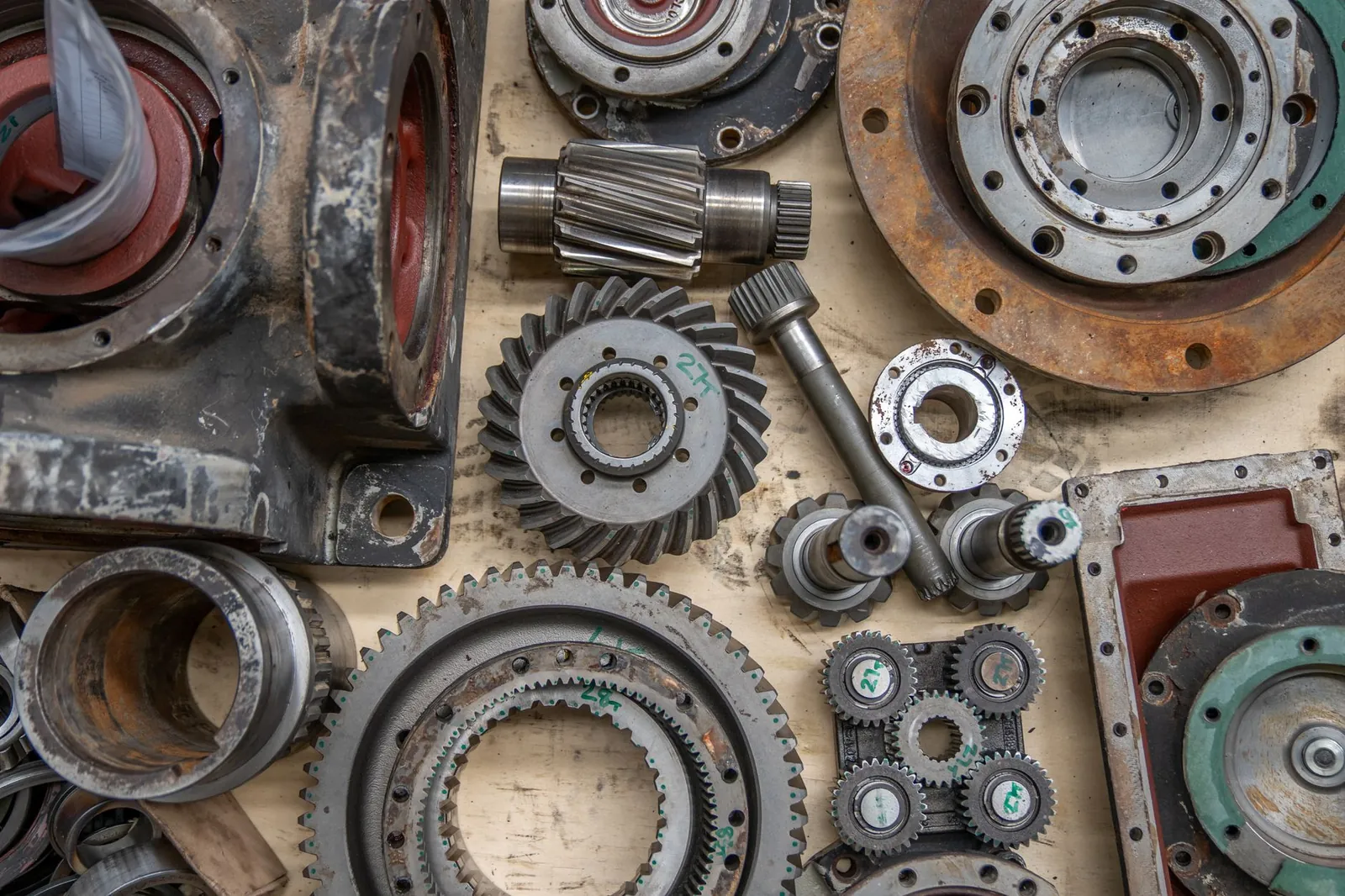 Detailed shot of industrial gears and mechanical parts in a workshop setting. Stock photo illustrating Tube Investments of India's regulatory approval story.