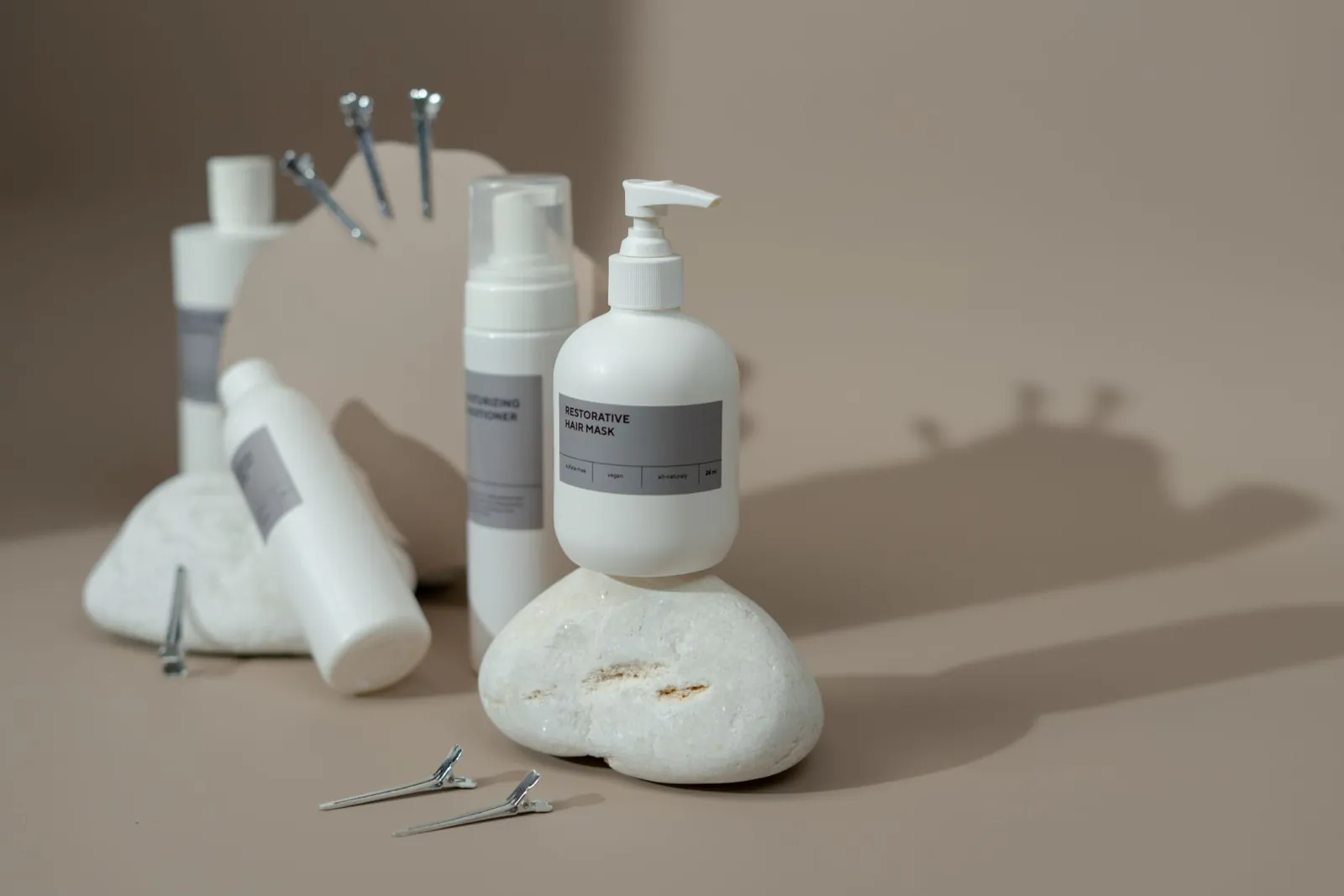 Stylish display of haircare products including shampoo and conditioner bottles on a minimalist set with neutral tones. Stock photo illustrating Marico's product launched story.