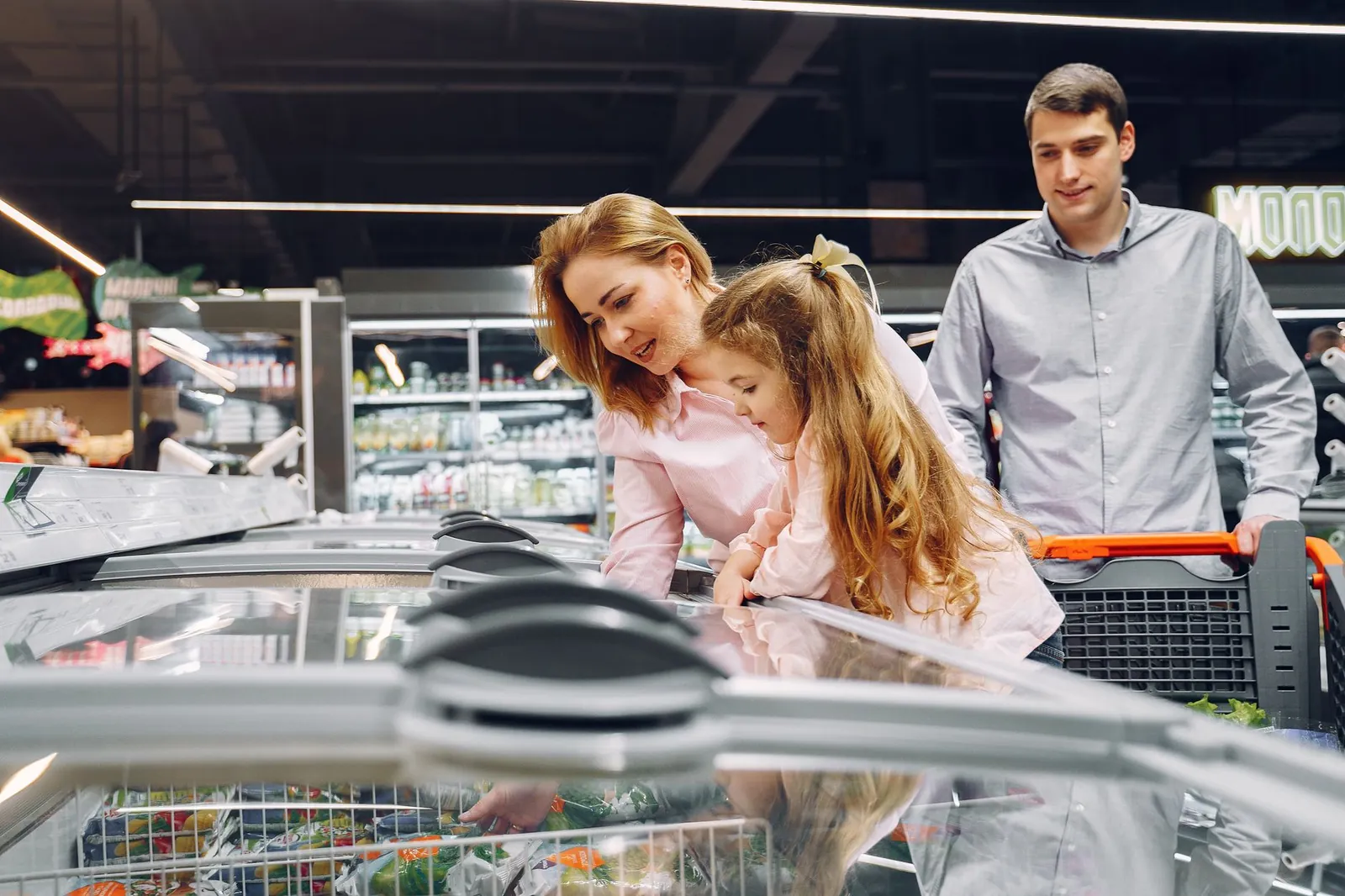 A happy family shopping in the supermarket's freezer section, emphasizing togetherness and love. Stock photo illustrating LG Electronics India's product launched story.