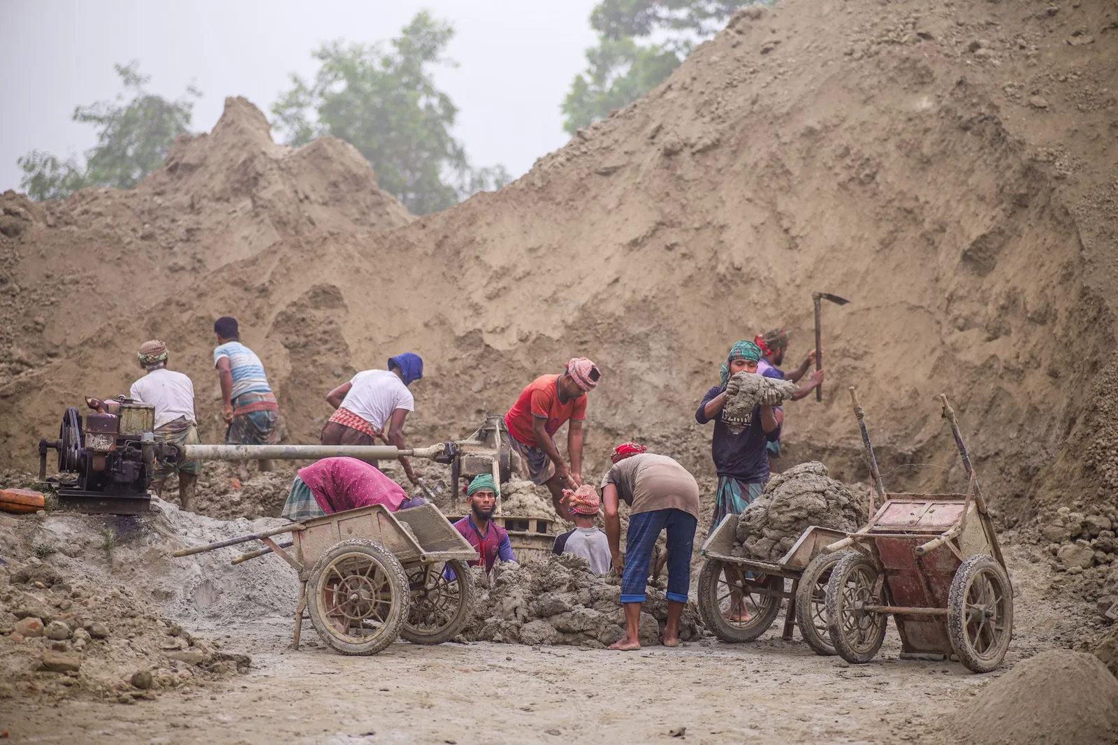 A group of workers laboring in an outdoor construction site, using tools and equipment. Stock photo illustrating Sobhagya Mercantile's new order story.