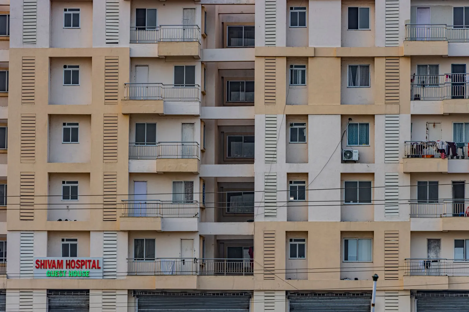 Front view of a multi-story residential building facade in Hazaribagh, India. Stock photo illustrating Artemis Medicare Services' production started story.