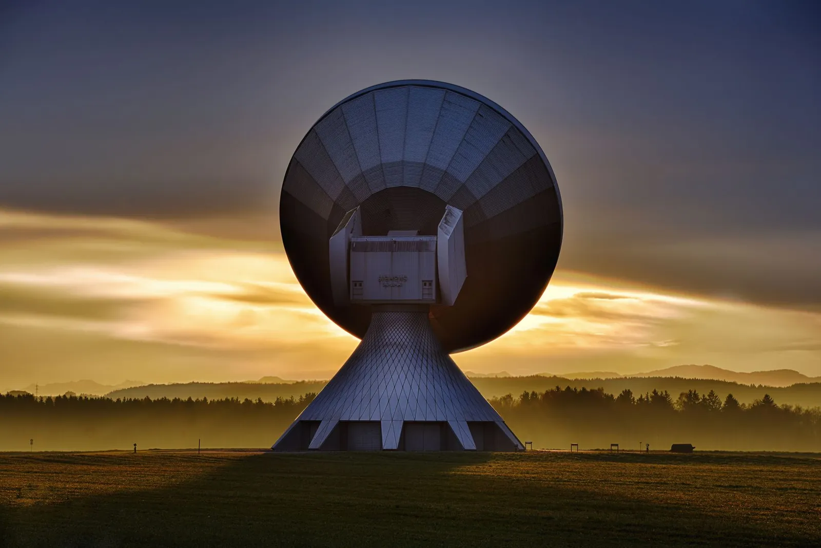 Large satellite dish silhouette against a colorful sunset, showcasing broadcasting technology. Stock photo illustrating Blue Cloud Softech Solutions' new order story.