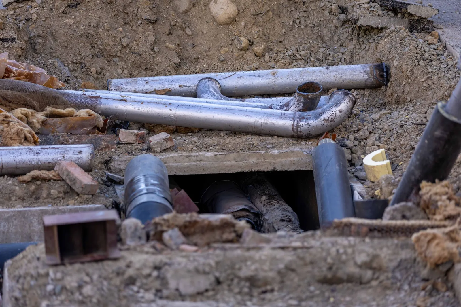 Close-up of urban pipe installation at a construction site, showing various pipes and materials. Stock photo illustrating Viviana Power Tech's new order story.