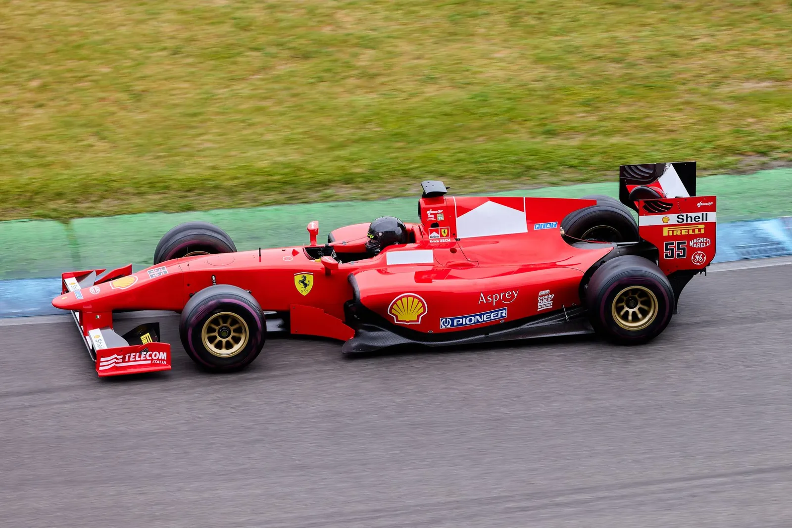 High-speed Formula 1 car in action on an outdoor racing track, showcasing motion and excitement. Stock photo illustrating Tata Consultancy Services' partnership story.