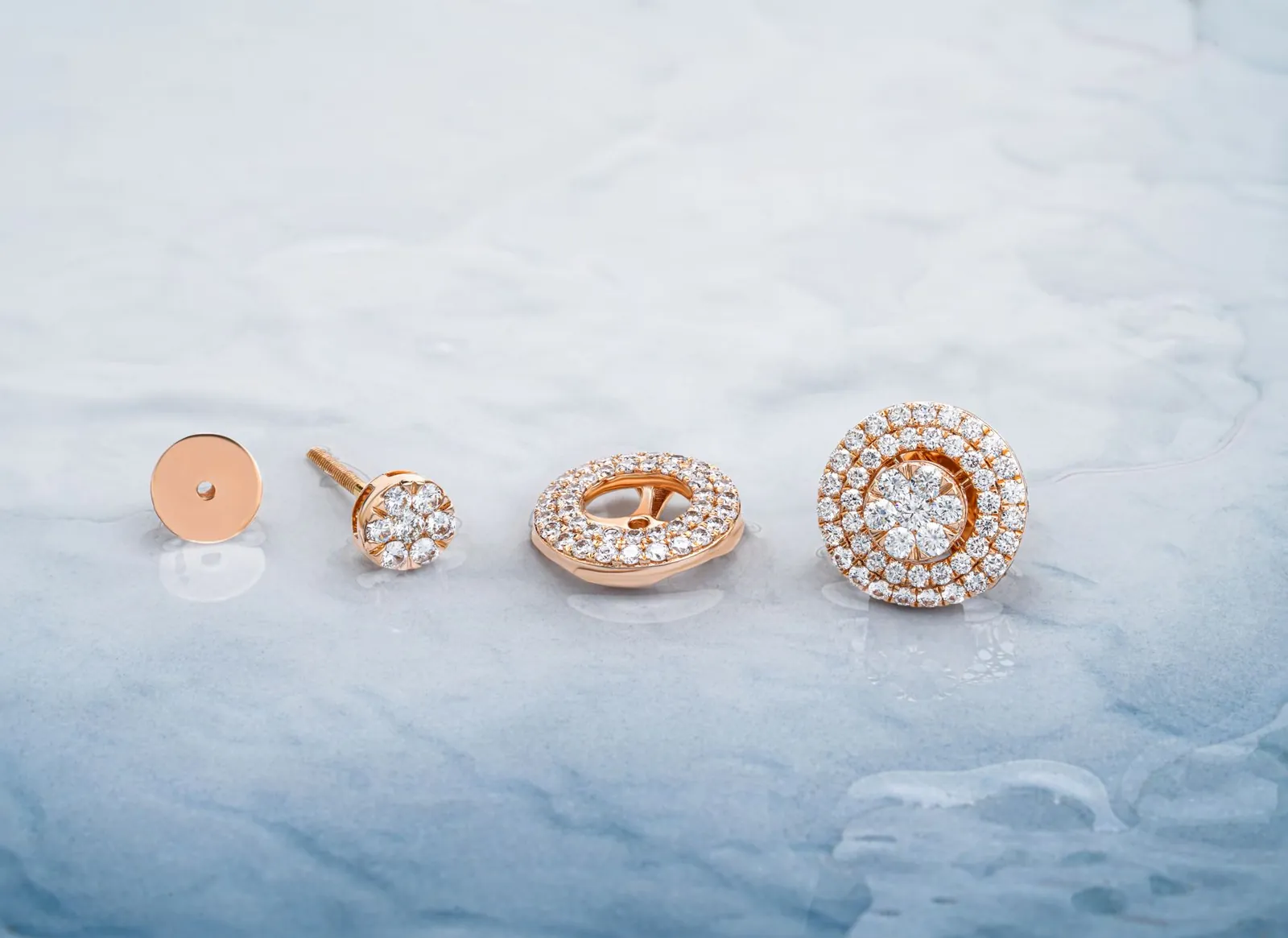 Close-up of rose gold diamond earrings displayed on a marble background in Surat, India. Stock photo illustrating Sky Gold And Diamonds' financial results story.