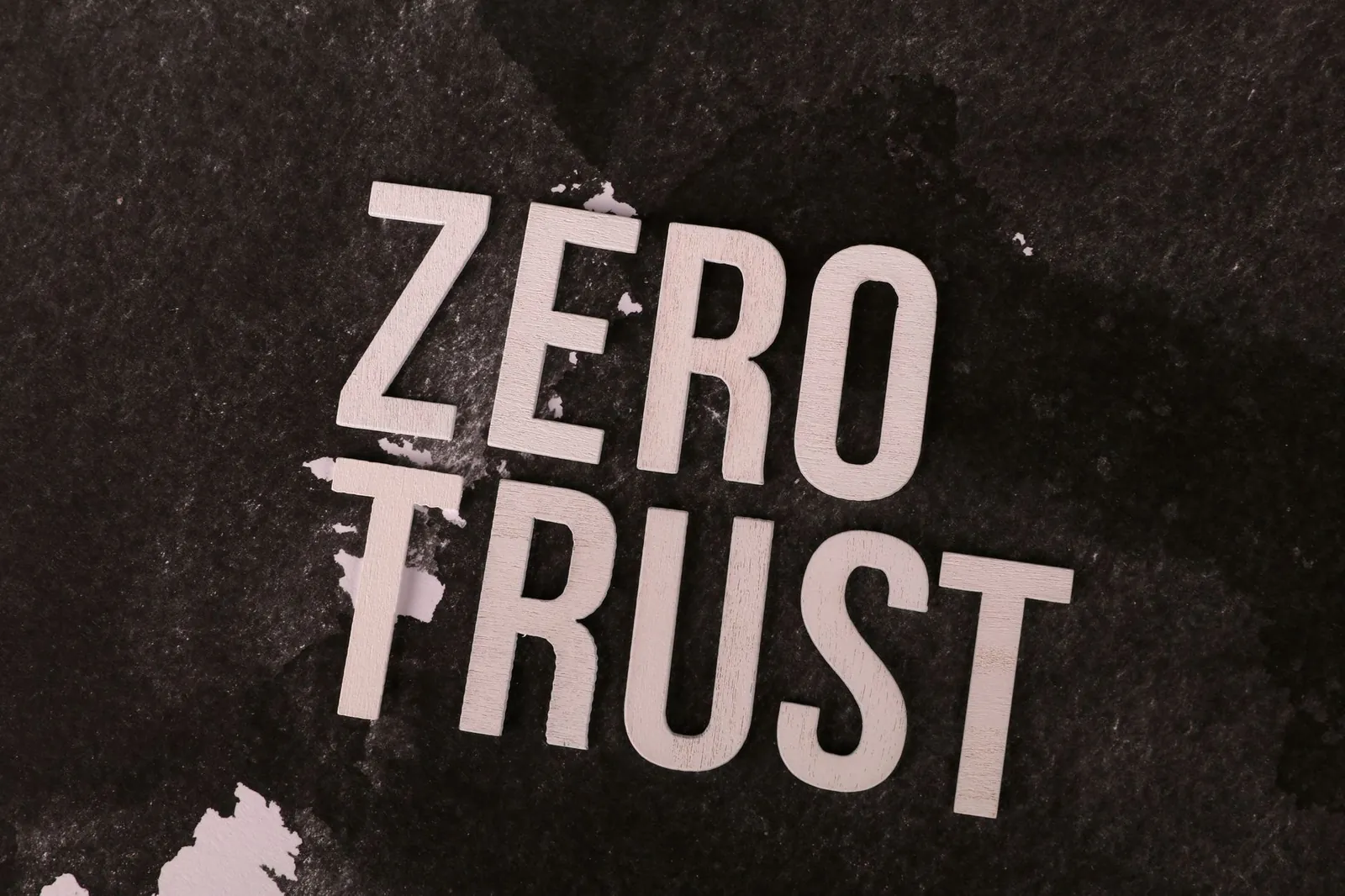 Bold 'Zero Trust' text against a textured black background, symbolizing cybersecurity. Stock photo illustrating Coforge's product launched story.