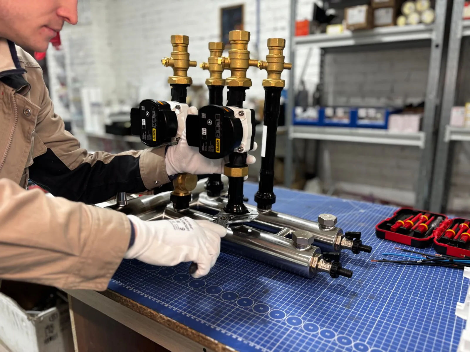 Engineer assembling a piping system for industrial heating, featuring valves and control units. Stock photo illustrating DEE Development Engineers' new order story.