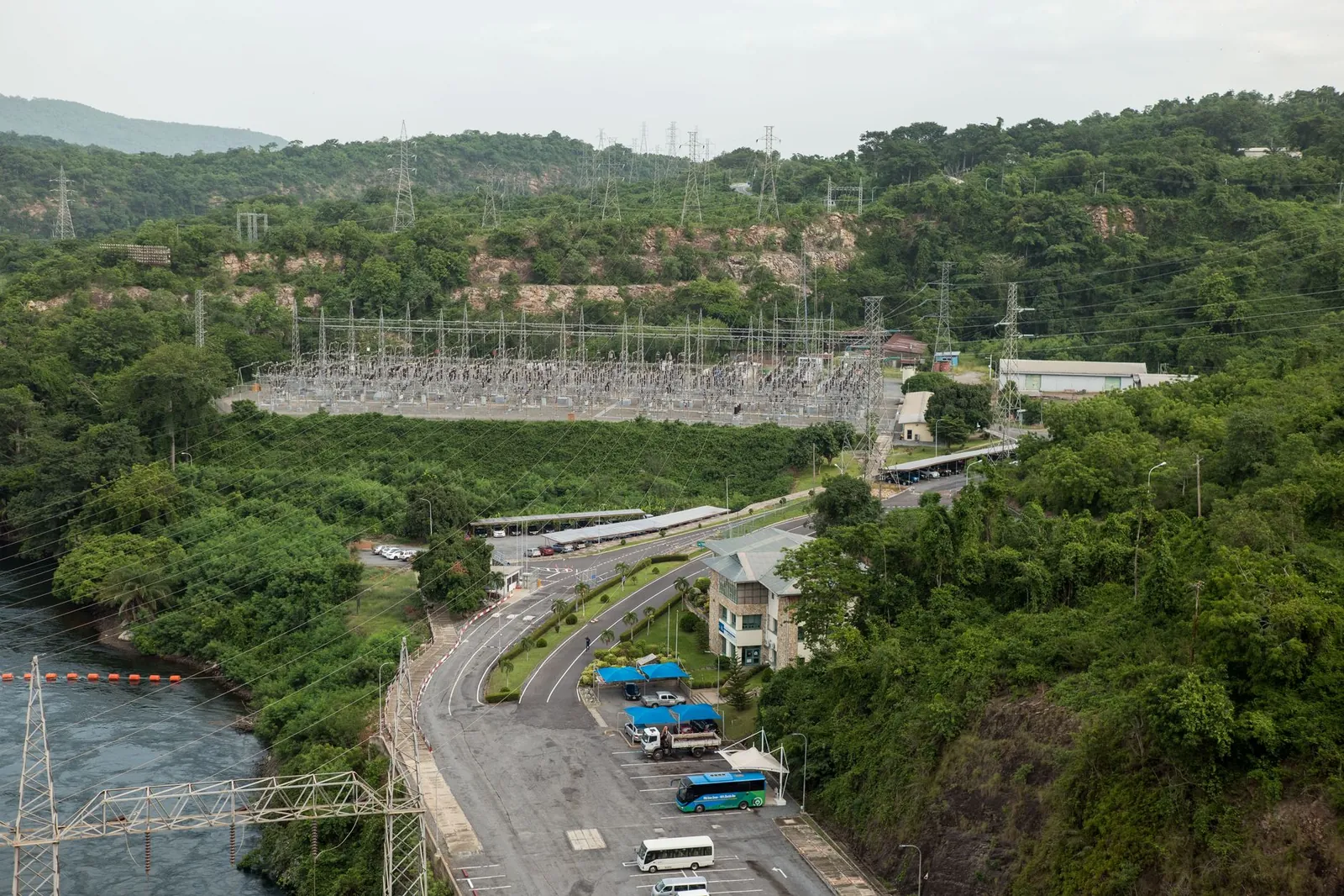 Aerial photograph showcasing a power station surrounded by lush green forest and river. Stock photo illustrating Alfa Transformers' new order story.