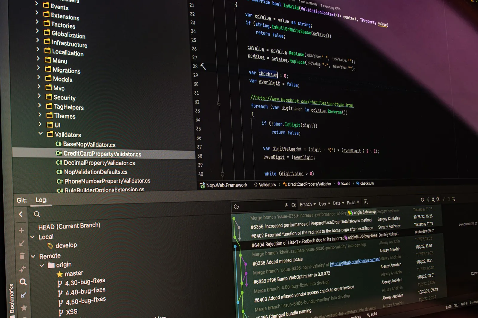 Close-up of software development tools displaying code and version control systems on a computer monitor. Stock photo illustrating Coforge's expansion story.