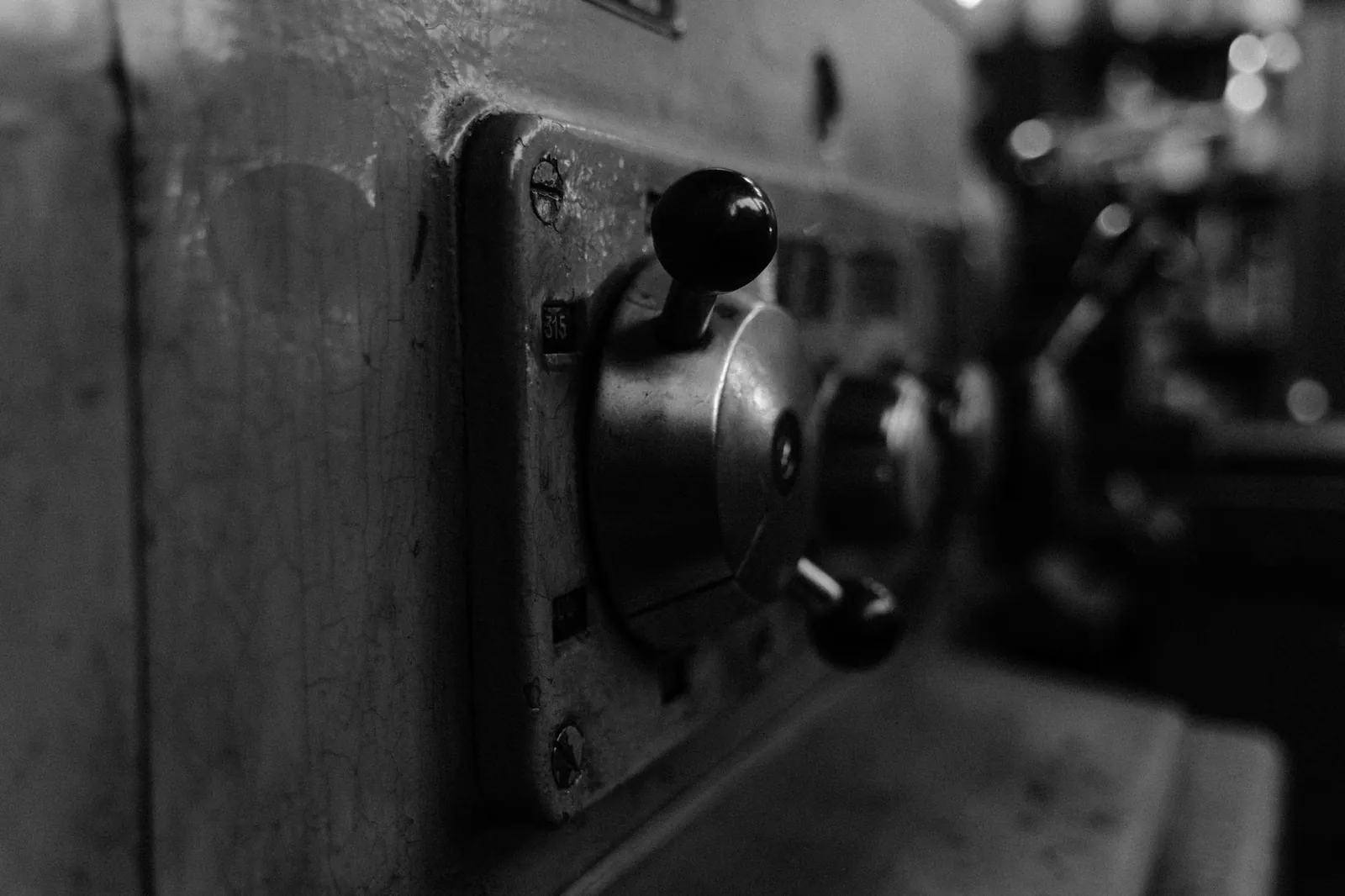 Detailed view of vintage machine control panel in black and white. Stock photo illustrating Kalpataru Projects International's expansion story.