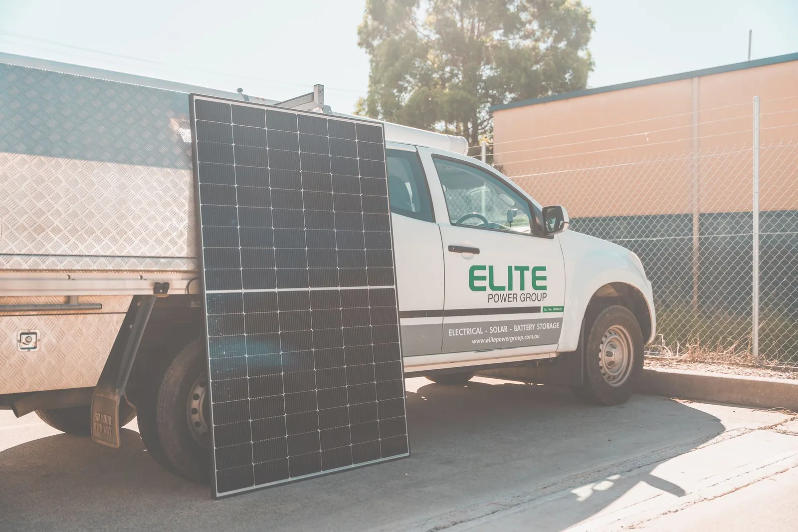 Solar panel leaning against utility truck promoting clean energy installation. Stock photo illustrating Solex Energy's new order story.