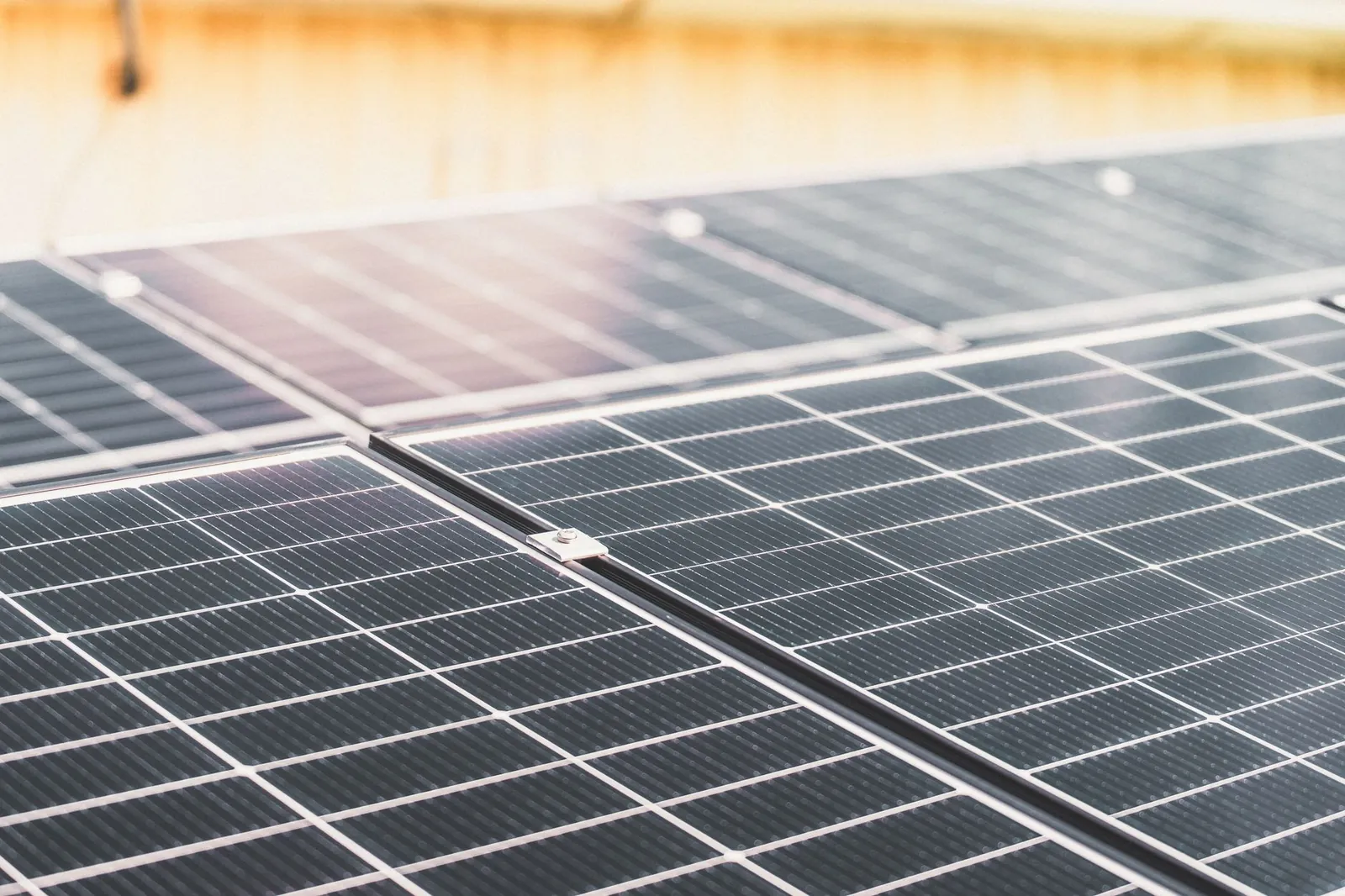 Detailed view of a rooftop solar panel array capturing sunlight for renewable energy production. Stock photo illustrating Solex Energy's new order story.
