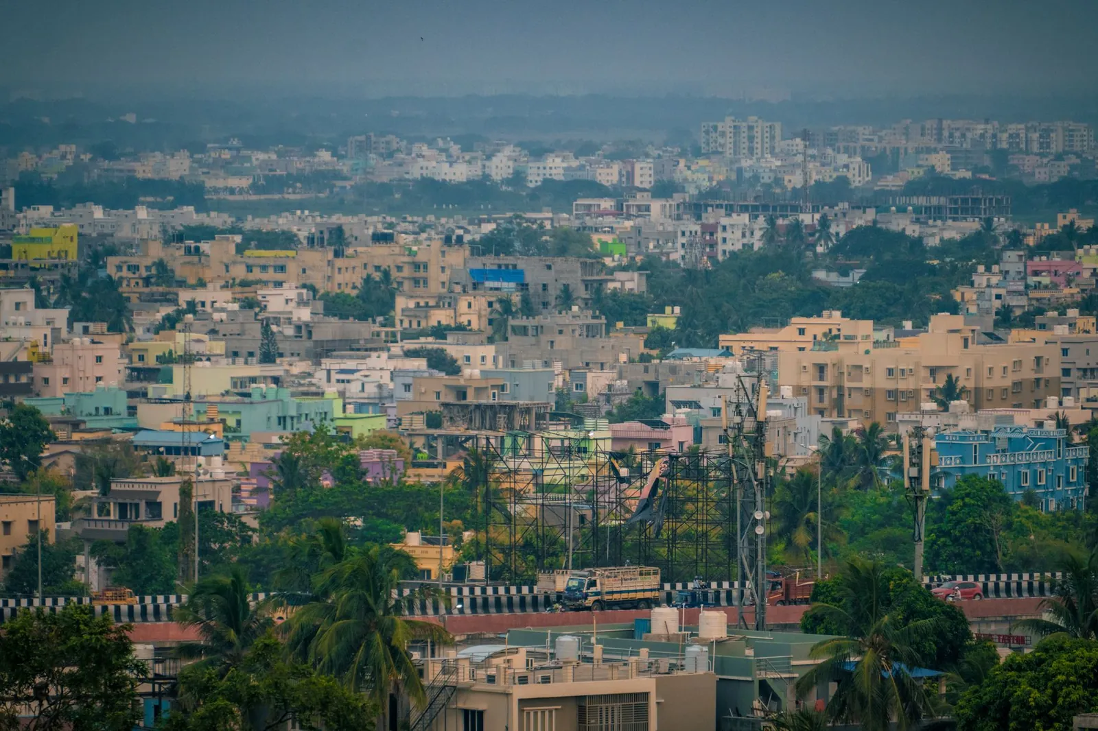 Aerial view of Bhubaneswar's colorful buildings and lush greenery, showcasing urban life in India. Stock photo illustrating Nila Infrastructures' financial results story.