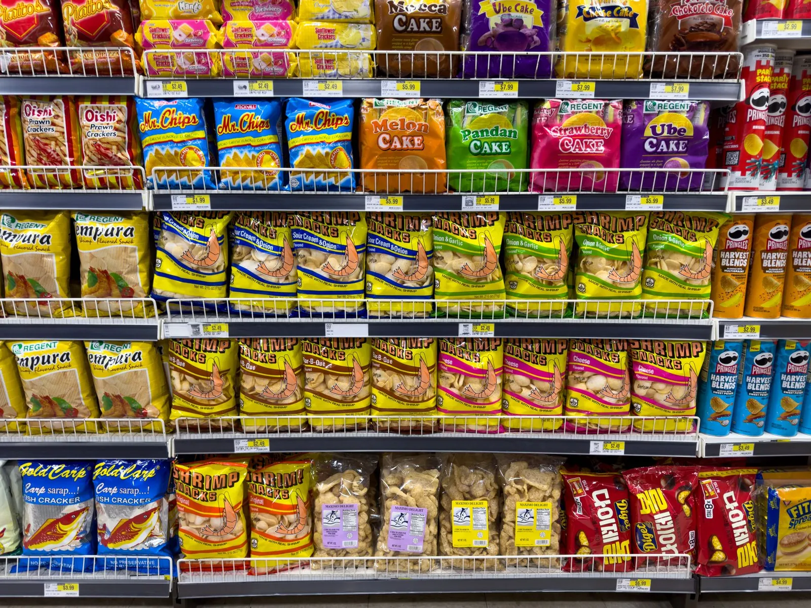 Colorful snack packages neatly displayed in a supermarket aisle showcasing Asian food variety. Stock photo illustrating Gopal Snacks' production started story.