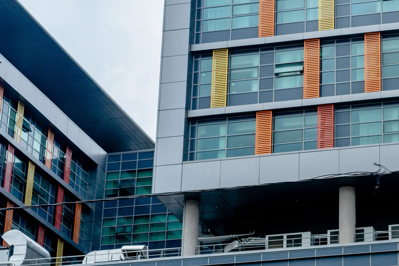 Modern building with colorful facade and glass windows showcasing urban architecture. Stock photo illustrating Fortis Healthcare's partnership story.