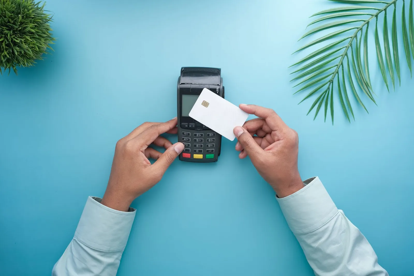 Hands using a contactless credit card on a payment terminal with a stylish minimal background. Stock photo illustrating Central Bank of India's product launched story.