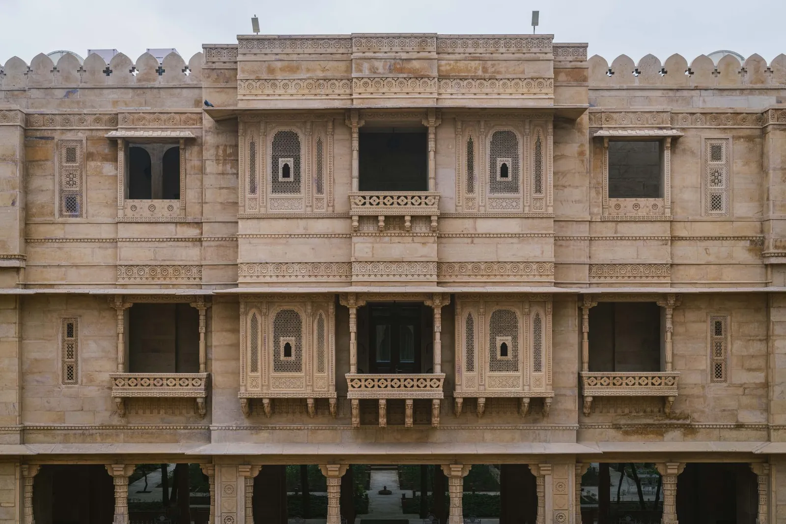 Impressive stone facade of a palace hotel in Jaisalmer, showcasing intricate architectural details. Stock photo illustrating City Union Bank's fund raise story.